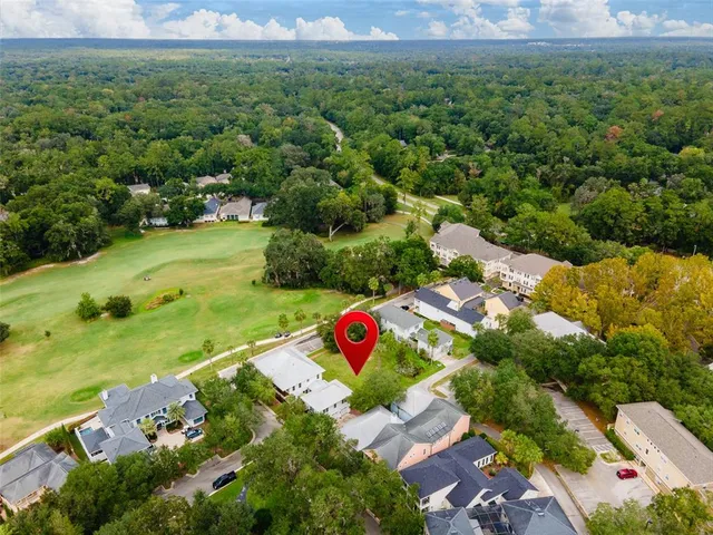 an aerial view of residential houses with outdoor space