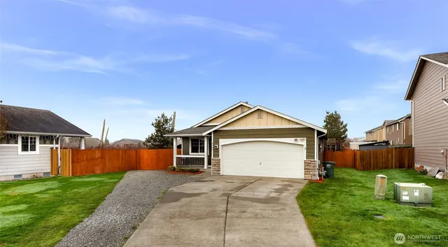 a front view of a house with a yard and garage
