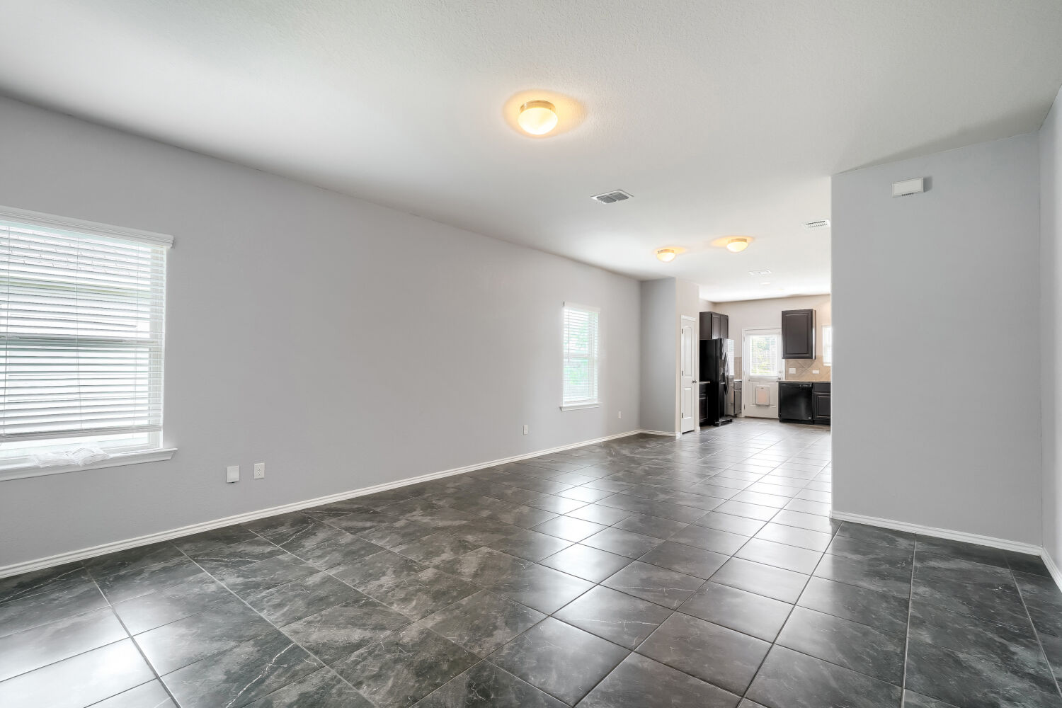 2420 Ranger Pass Seguin, TX 78155 - Photo 5 of 28 Spacious interior featuring large format tile flooring, light gray wall finishes, and white baseboards