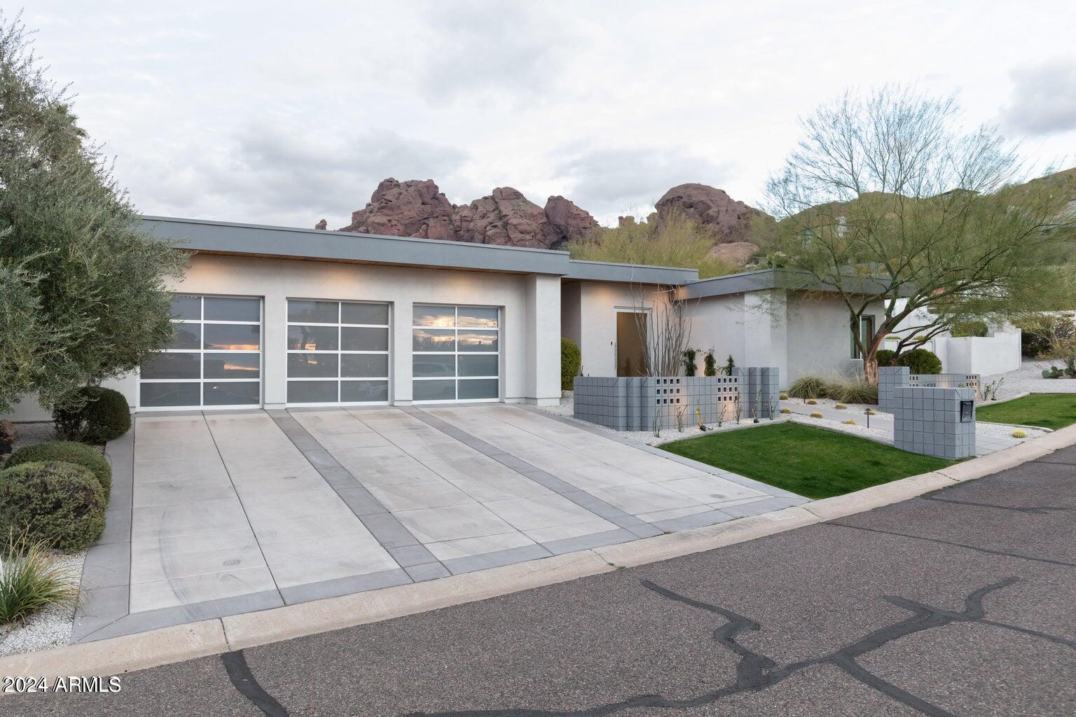 5833 North 46th Street Phoenix, AZ 85018 - Photo 2 of 29 a front view of a house with a yard and garage