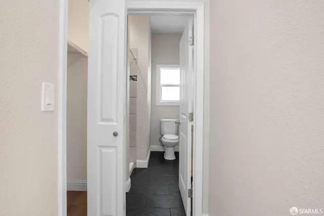 a view of a bathroom from a hallway with toilet