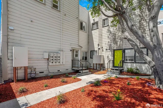 a backyard of a house with barbeque oven and outdoor seating