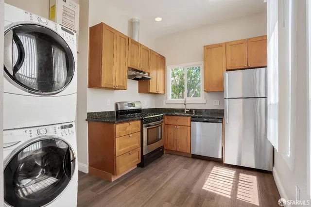 a kitchen with a refrigerator and a sink