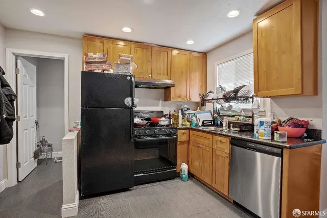 a kitchen with a refrigerator and a sink