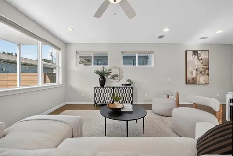 a living room with furniture and wooden floor