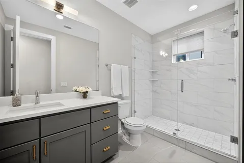 a spacious bathroom with a sink mirror and