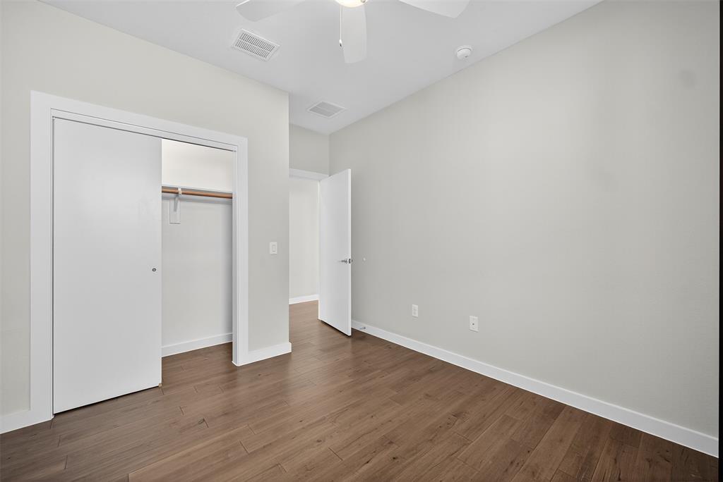 5333 Anita Street Dallas, TX 75206 - Photo 22 of 30 a view of an empty room with wooden floor and closet