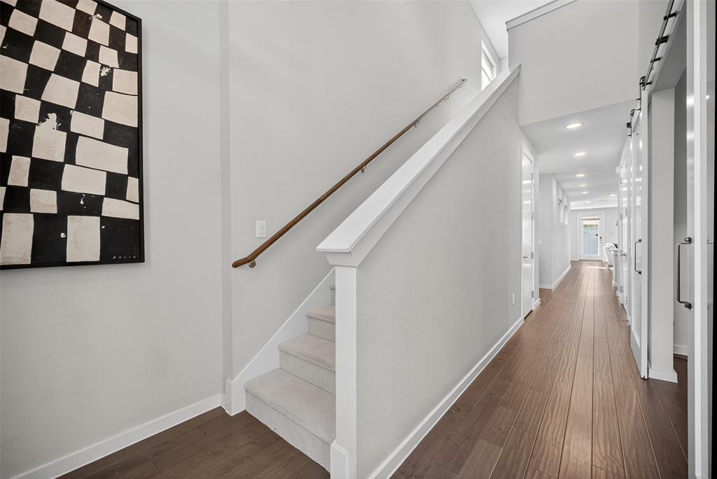 5333 Anita Street Dallas, TX 75206 - Photo 5 of 30 a view of a hallway with wooden floor and staircase