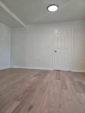 a view of an empty room and wooden floor
