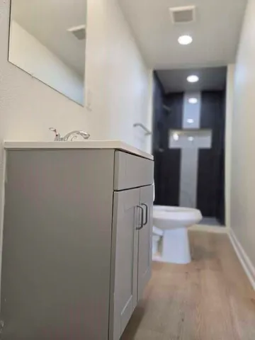 a bathroom with a toilet and a shower