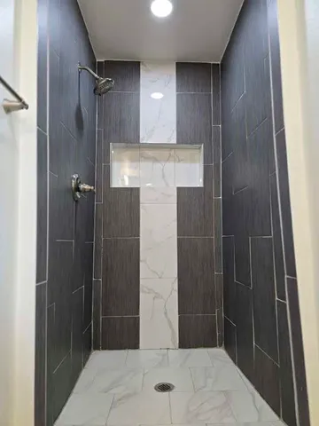 a bathroom with a shower and a sink