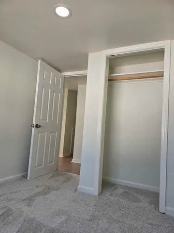 an empty room with walk in closet