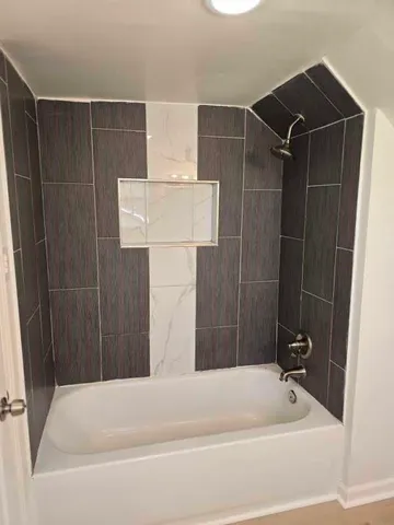 a bathroom with a bathtub and shower