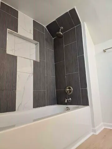 a bathroom with a tub and shower