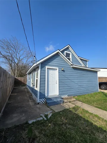 a front view of house with a garden