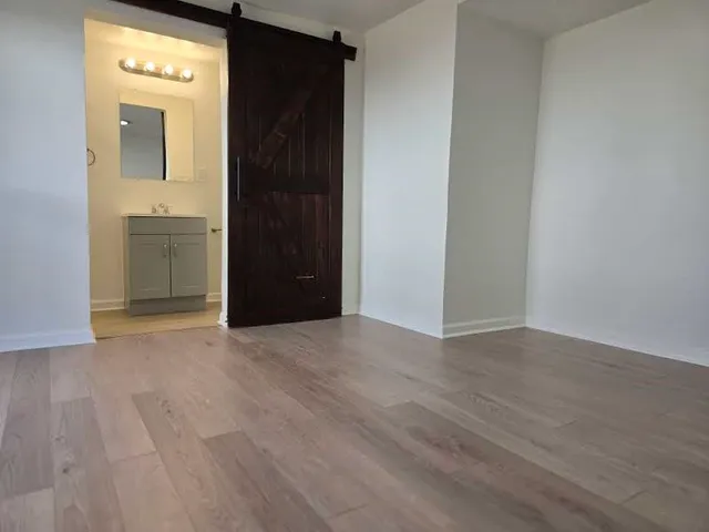 a view of a hallway with wooden floor