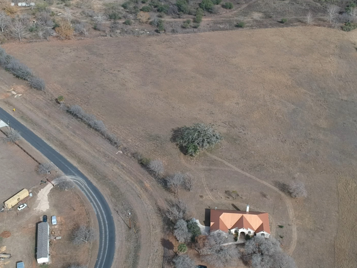 0 Wisdom Road Atascosa, TX 78002 - Photo 5 of 8 a view of a dry yard with wooden fence