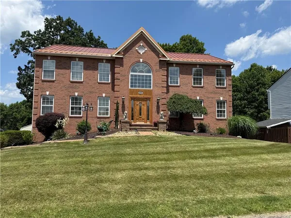 a front view of a house with a yard