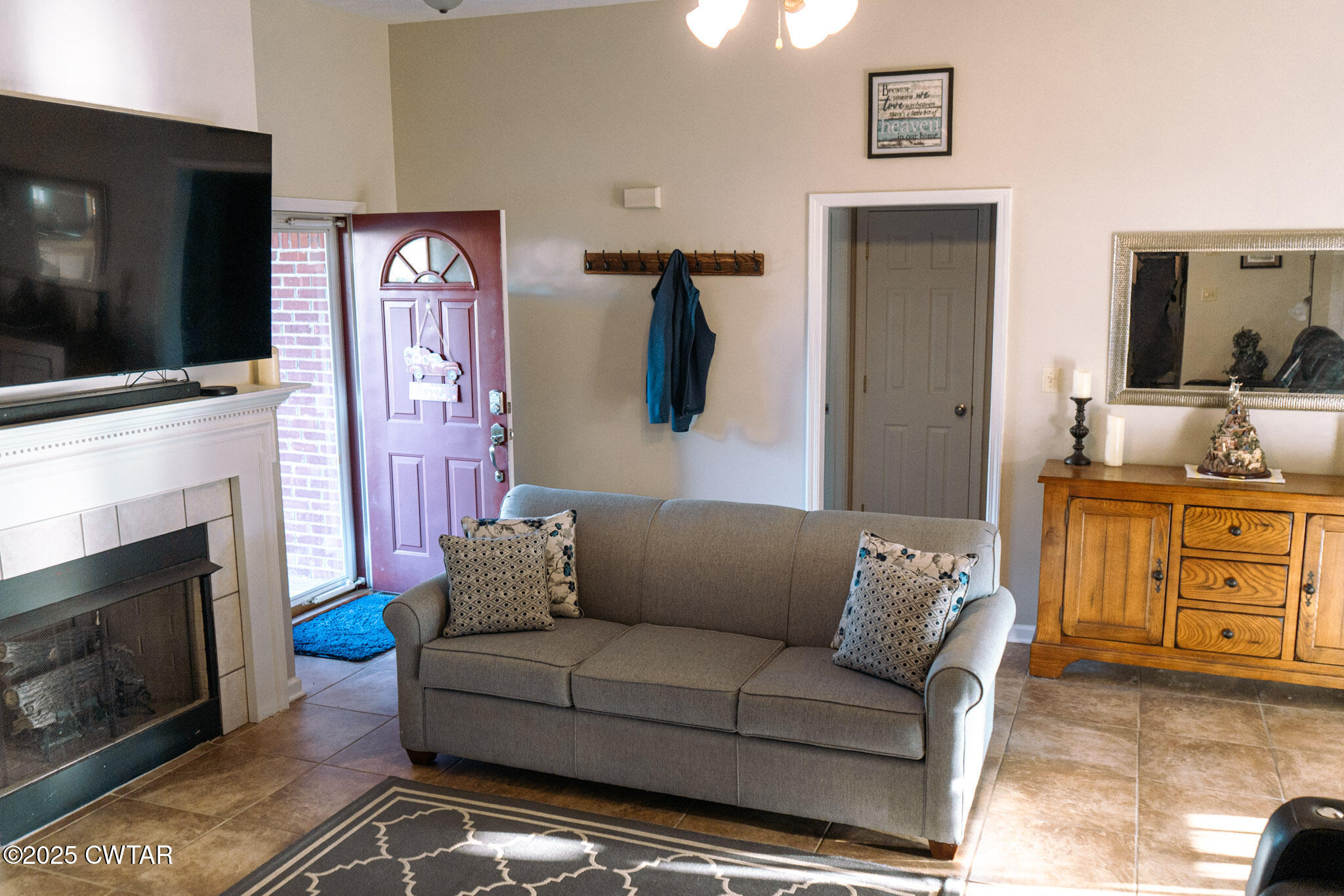 15 Battery Cove Jackson, TN 38305 - Photo 14 of 25 a living room with furniture a flat screen tv and a fireplace