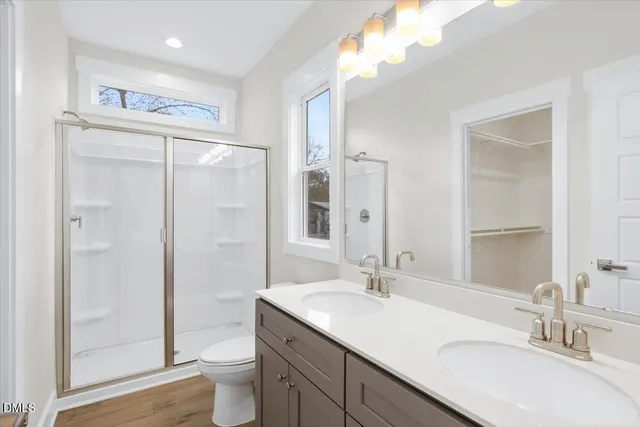 a bathroom with a sink toilet and shower