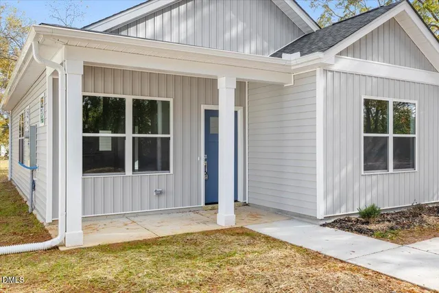 a view of a house with small yard