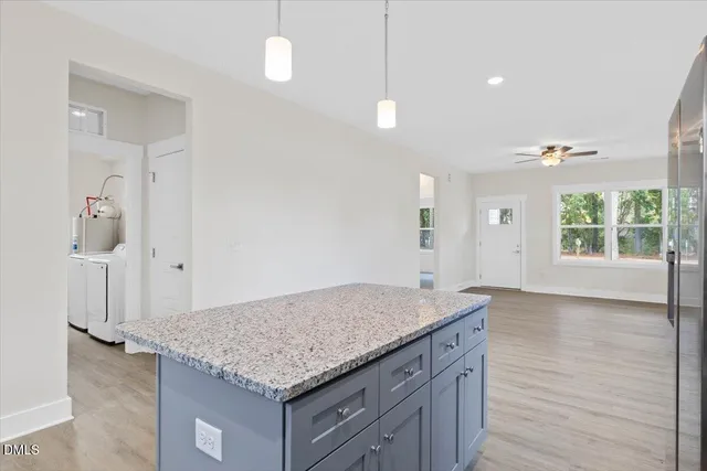 an empty room with kitchen appliances and windows
