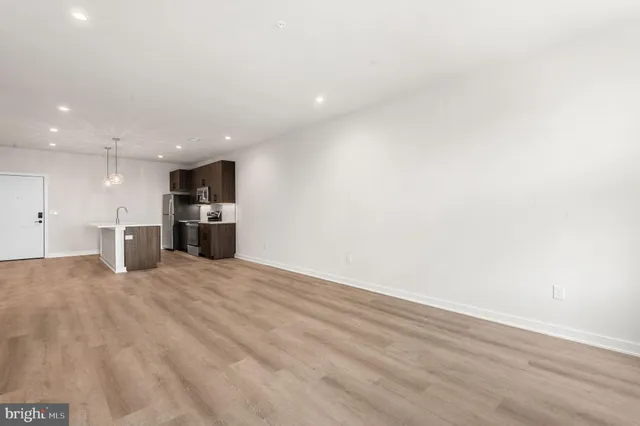 a view of a kitchen with a refrigerator and a sink