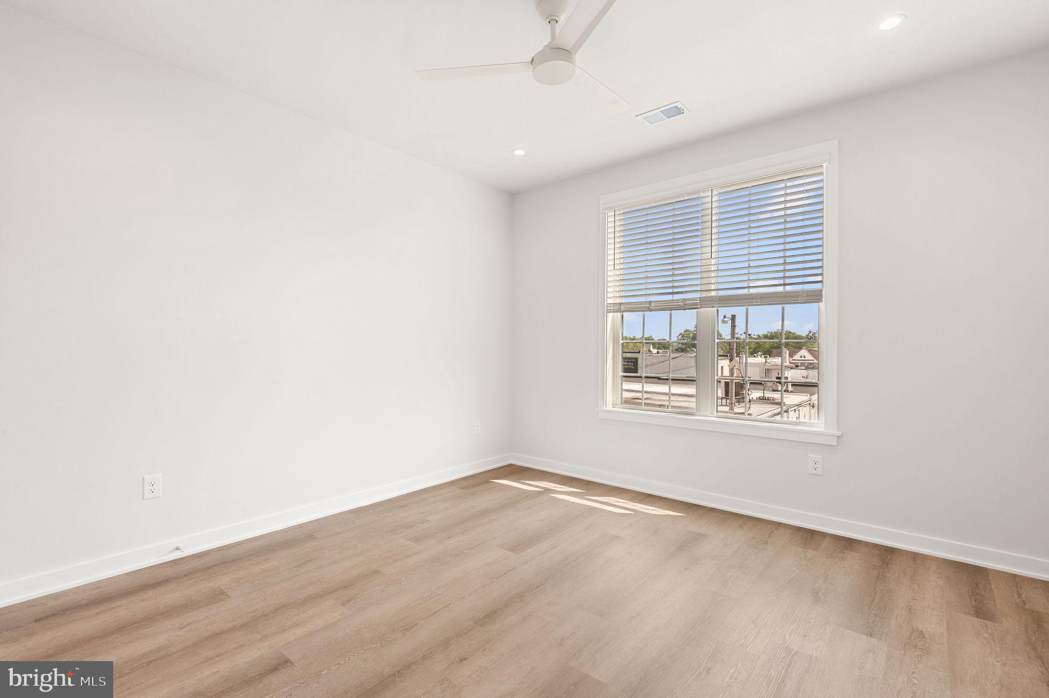 26 South York Road, Unit 403 Hatboro, PA 19040 - Photo 15 of 52 an empty room with wooden floor and windows
