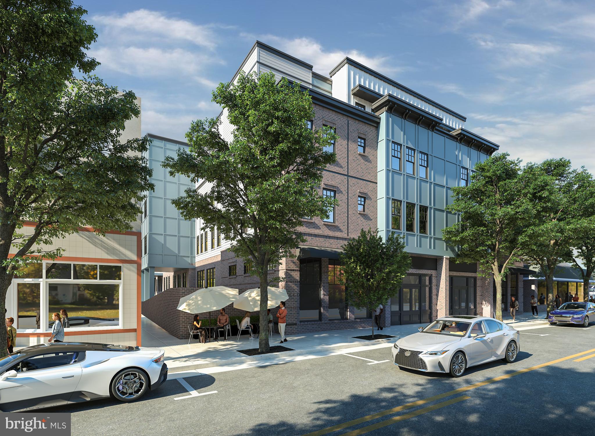 26 South York Road, Unit 403 Hatboro, PA 19040 - Photo 4 of 51 a car parked in front of a brick house with a small yard