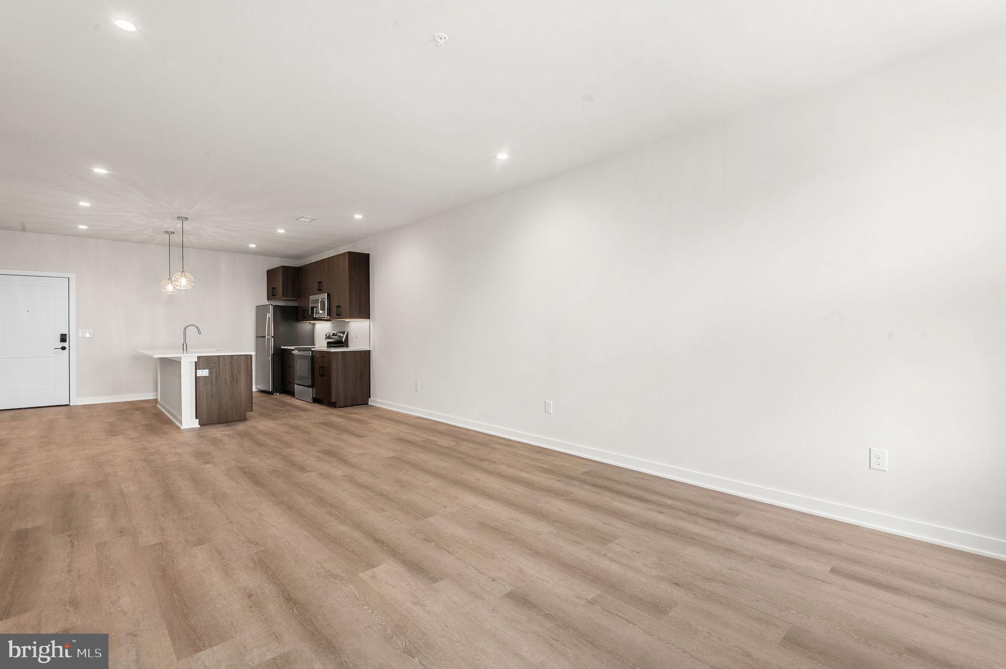 26 South York Road, Unit 403 Hatboro, PA 19040 - Photo 10 of 51 a view of kitchen with refrigerator stove microwave and cabinets