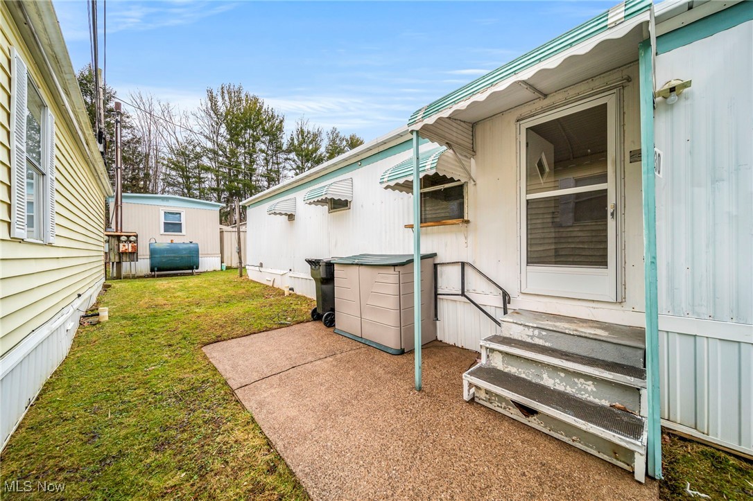 9735 Chillicothe Road, Unit 30 Kirtland, OH 44094 - Photo 7 of 10 View of grassy yard with entry steps and oil tank