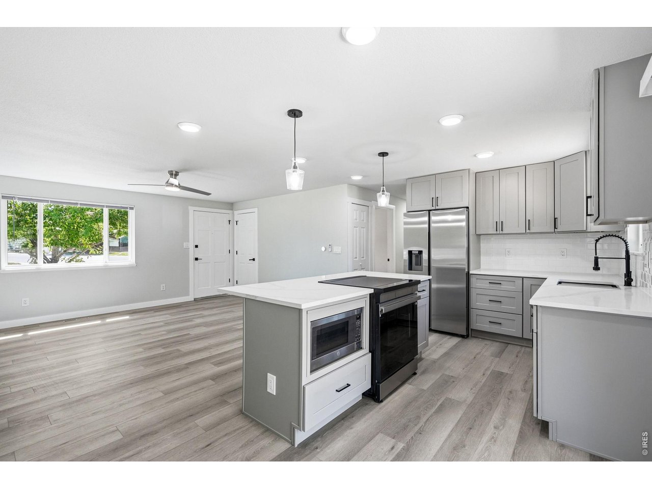 1035 6th Street Berthoud, CO 80513 - Photo 15 of 37 a kitchen with stainless steel appliances granite countertop a stove a sink and a refrigerator