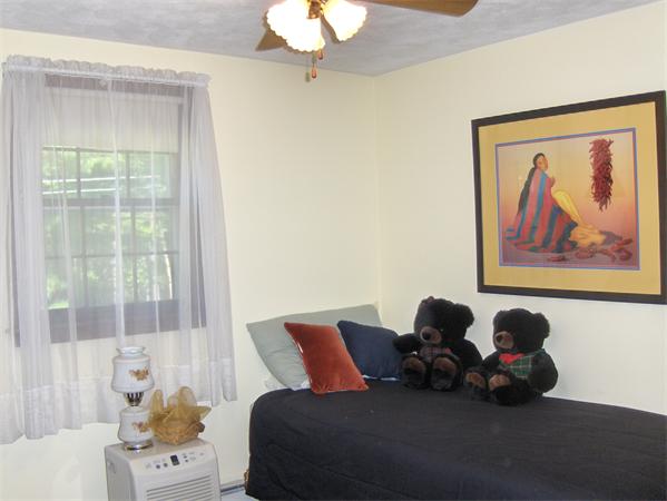 1754 Shirley Road Lancaster, MA 01523 - Photo 21 of 30 a bed room with a bed and a painting on the wall