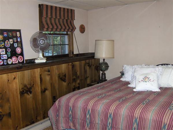 1754 Shirley Road Lancaster, MA 01523 - Photo 24 of 30 a bedroom with a bed a painting on the wall and a window