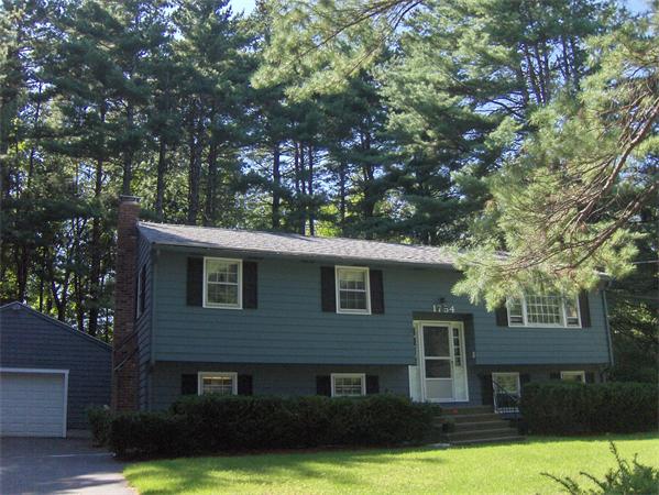 1754 Shirley Road Lancaster, MA 01523 - Photo 30 of 30 a front view of a house with a yard garage and outdoor seating