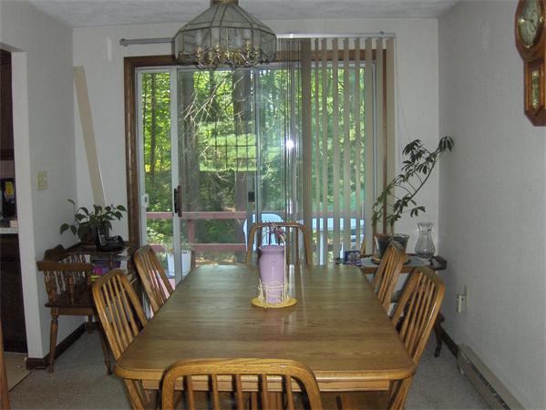 1754 Shirley Road Lancaster, MA 01523 - Photo 9 of 30 a dining room with furniture a chandelier and wooden floor