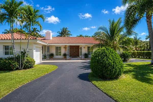 a front view of a house with a yard and porch