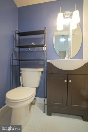 a bathroom with a toilet a sink and mirror