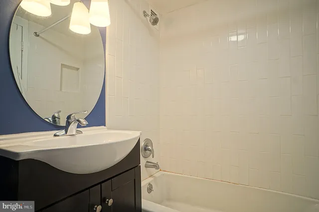 a bathroom with a sink a mirror and a vanity