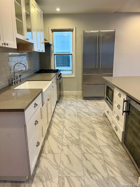86-09 125th Street, Unit 2 Queens, NY 11418 - Photo 1 of 16 a large white kitchen with a sink a stove and a refrigerator