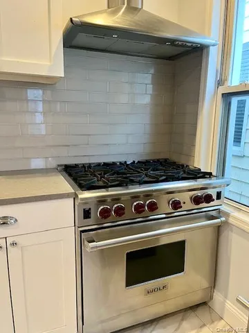 a stove top oven sitting inside of a kitchen