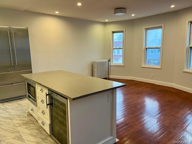 86-09 125th Street, Unit 2 Queens, NY 11418 - Photo 2 of 16 a kitchen with a stove and wooden floor