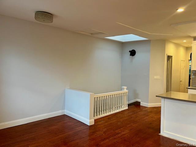 86-09 125th Street, Unit 2 Queens, NY 11418 - Photo 3 of 16 an empty room with wooden floor and a window