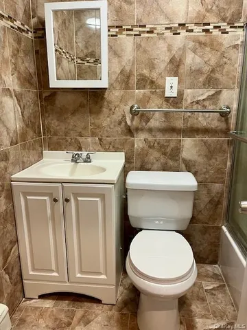 a white toilet sitting next to a bathroom sink