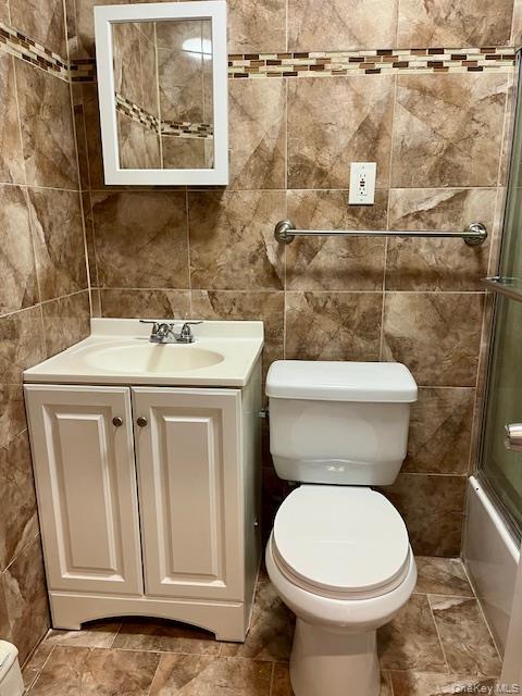 86-09 125th Street, Unit 2 Queens, NY 11418 - Photo 4 of 16 a white toilet sitting next to a bathroom sink
