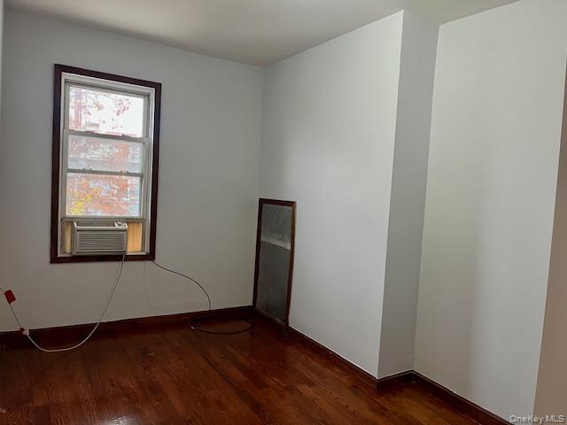 86-09 125th Street, Unit 2 Queens, NY 11418 - Photo 9 of 16 an empty room with wooden floor and windows