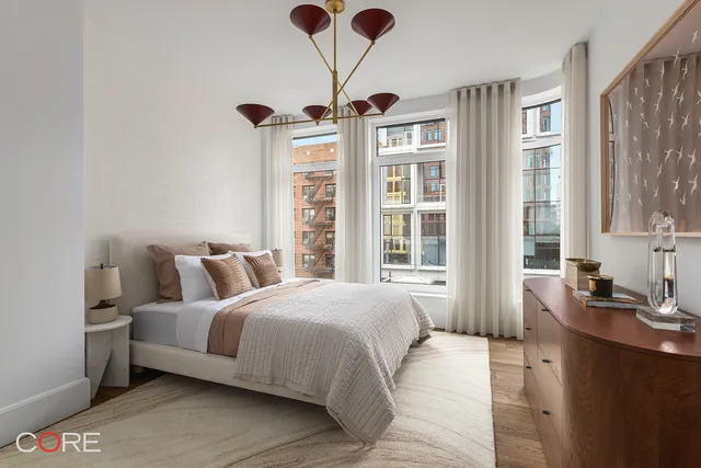 a bedroom with bed and a large window