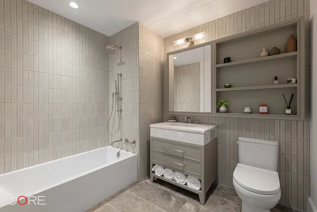 a bathroom with a toilet a sink and bathtub