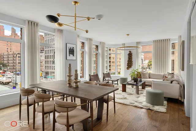 a view of a livingroom with furniture window and wooden floor