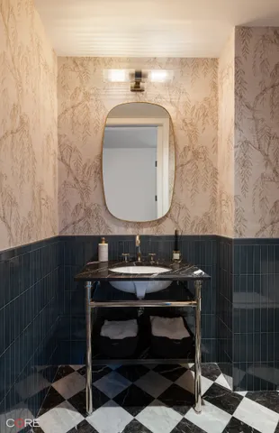 a bathroom with a sink a mirror and a toilet